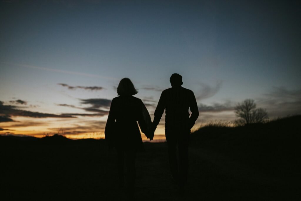 Couple holding hands in the night