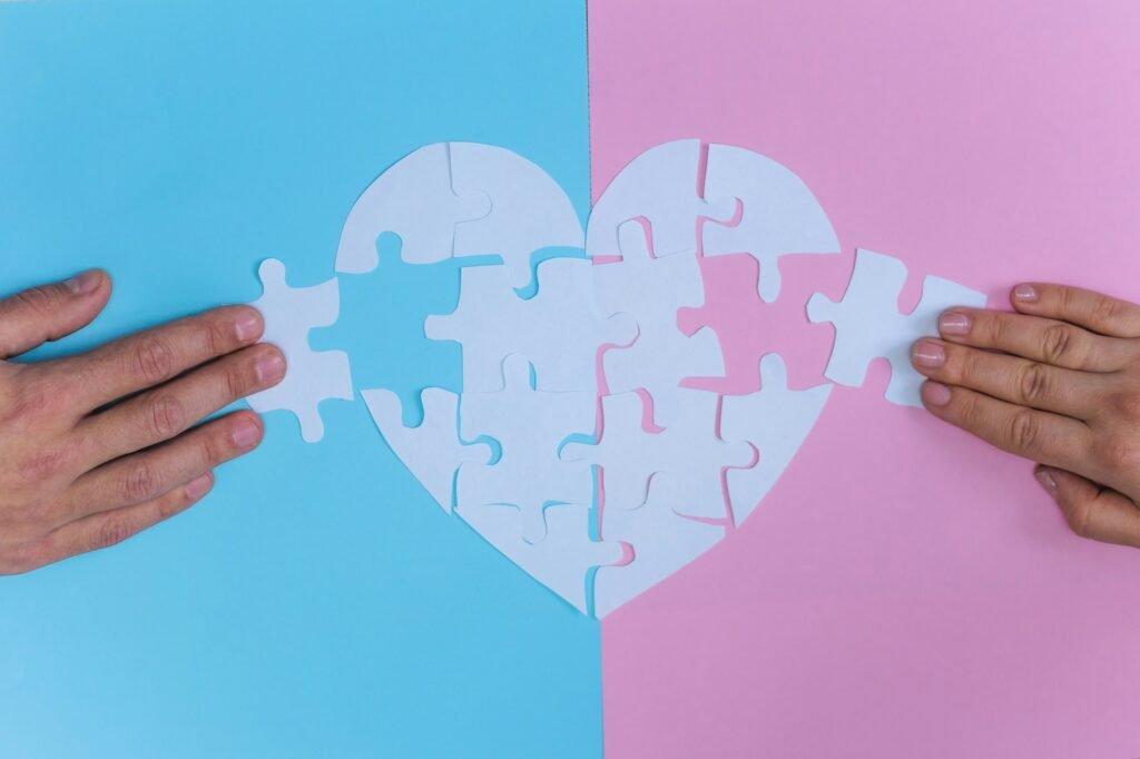 Top view man and woman collect heart shaped puzzle